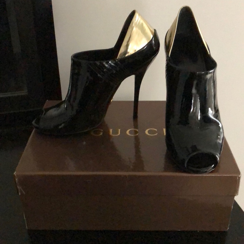 Gucci patent bootie with gold detail on heel